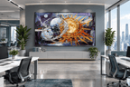 Celestial Counterpoint abstract artwork above a grey credenza in a bright open-plan office with floor-to-ceiling city windows, desks and leafy plants.