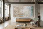 Chalk Current abstract artwork with textured cream and weathered stone fields transitioning into muted teal-blue at the right in an industrial loft