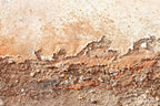 Zoom of Ember Course abstract artwork with a broad chalk-cream plaster field and a low fractured course of rust, terracotta, umber and granular stone residue