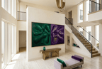 Emerald & Amethyst biomorphic diptych artwork with dark emerald, violet and muted-gold contours in a luxury two stroy foyer