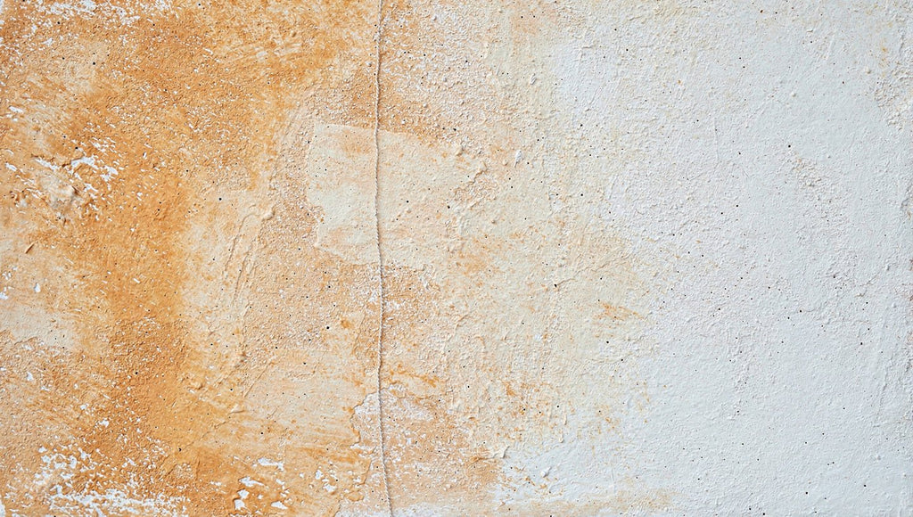 Lime Drift abstract artwork with textured ochre and terracotta pigment concentrated at left, a softened central vertical seam, and a broad chalk-white plaster-like field at right