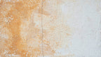 Lime Drift abstract artwork with textured ochre and terracotta pigment concentrated at left, a softened central vertical seam, and a broad chalk-white plaster-like field at right