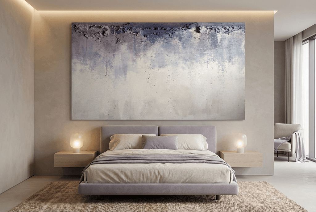 Overburden abstract artwork with a dark slate-violet plaster-like accumulation and fine drips above a chalk-white field with pale blue-grey veils in a modern hotel room
