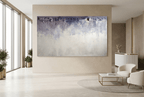 Overburden abstract artwork with a dark slate-violet plaster-like accumulation and fine drips above a chalk-white field with pale blue-grey veils in a modern hotel lobby