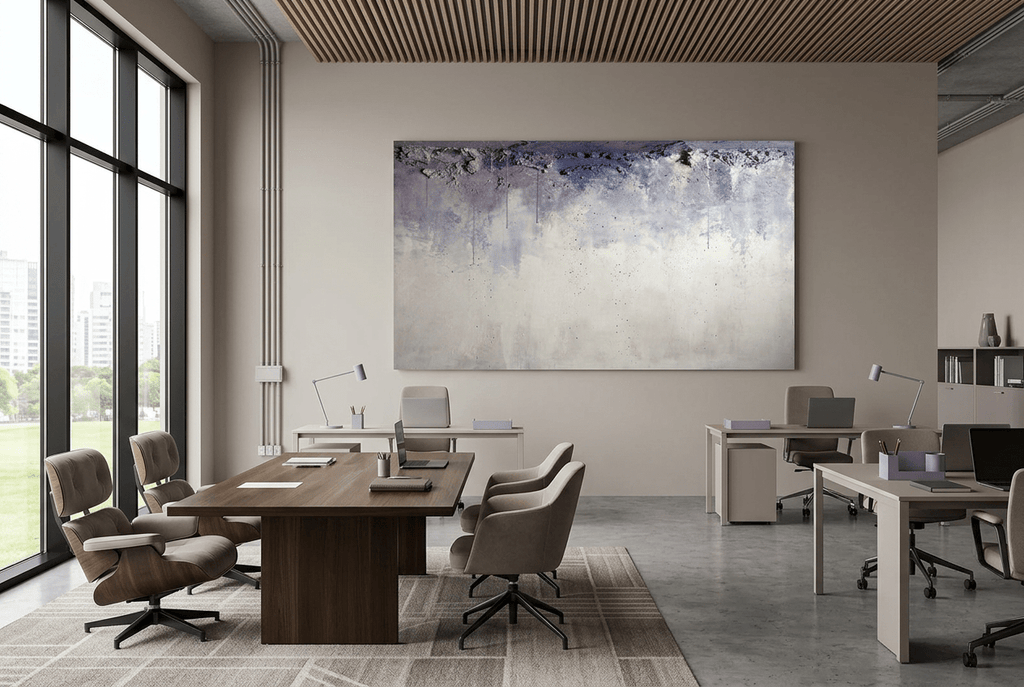 Overburden abstract artwork with a dark slate-violet plaster-like accumulation and fine drips above a chalk-white field with pale blue-grey veils in an open-plan office