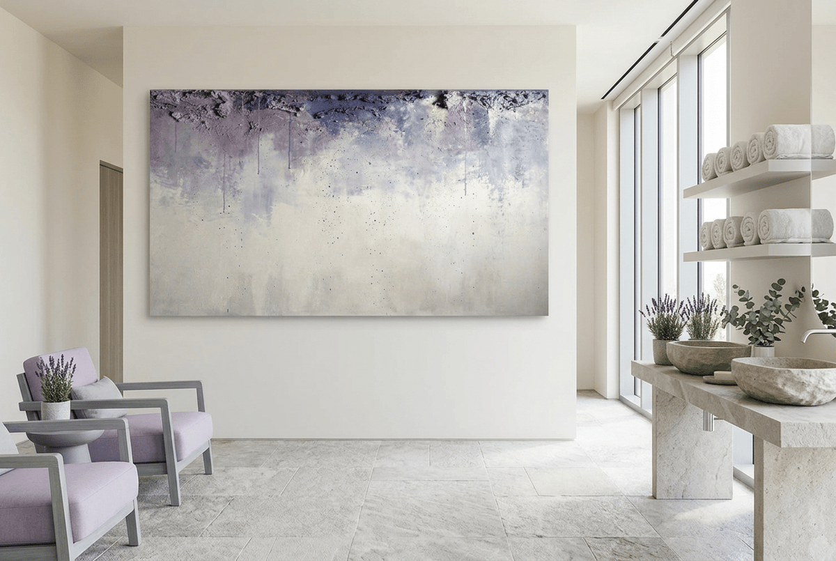 Overburden abstract artwork with a dark slate-violet plaster-like accumulation and fine drips above a chalk-white field with pale blue-grey veils in a wellness spa