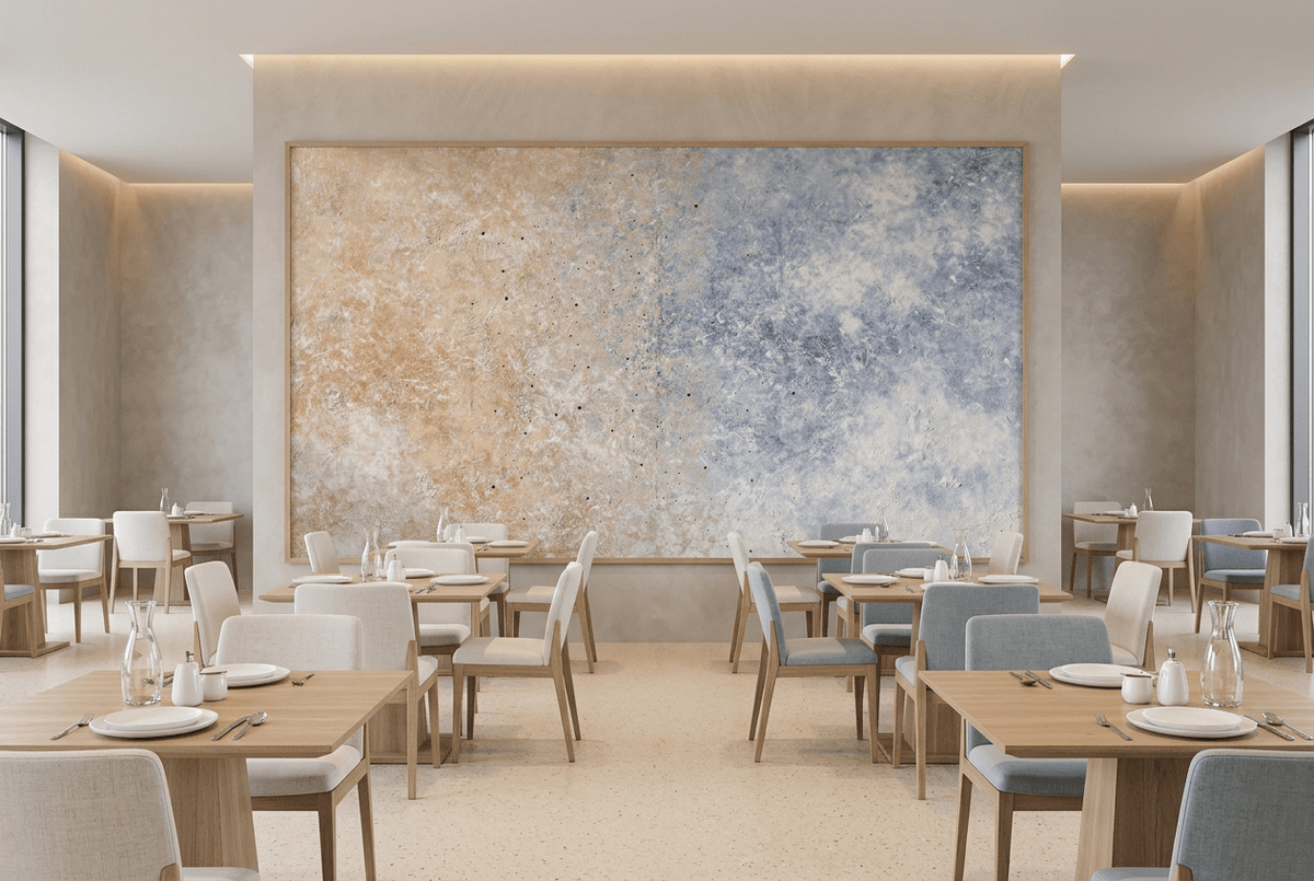 Pale Confluence panoramic abstract artwork with soft peach and shell-pink plaster-like texture at left dissolving into a powder-blue, dove-grey and chalk-white field in a modern restaurant
